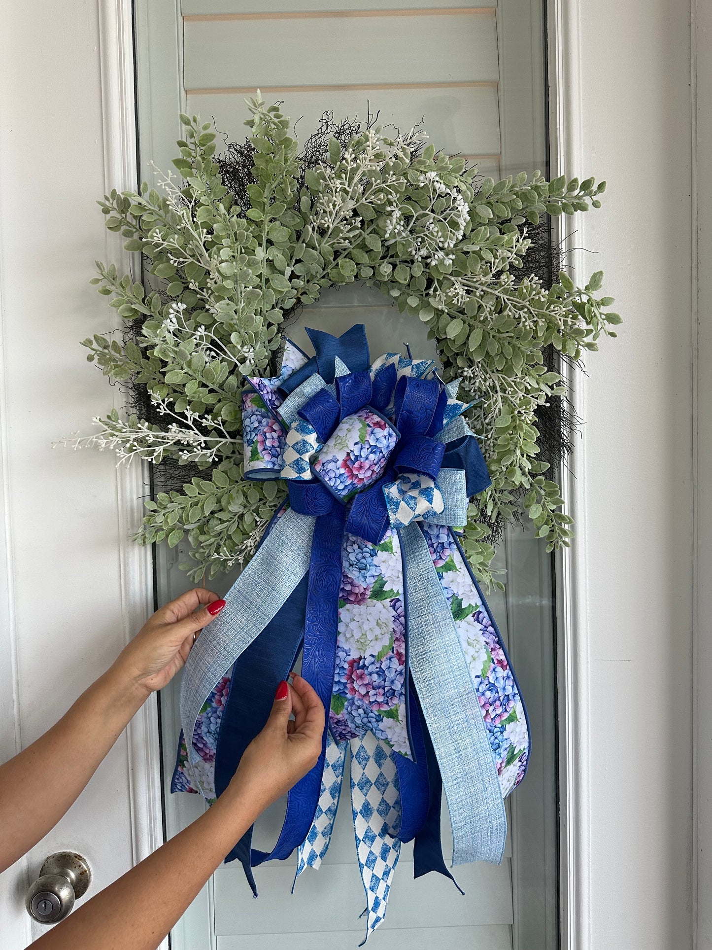 White eucalyptus, and berries with blue, light blue and floral ribbons