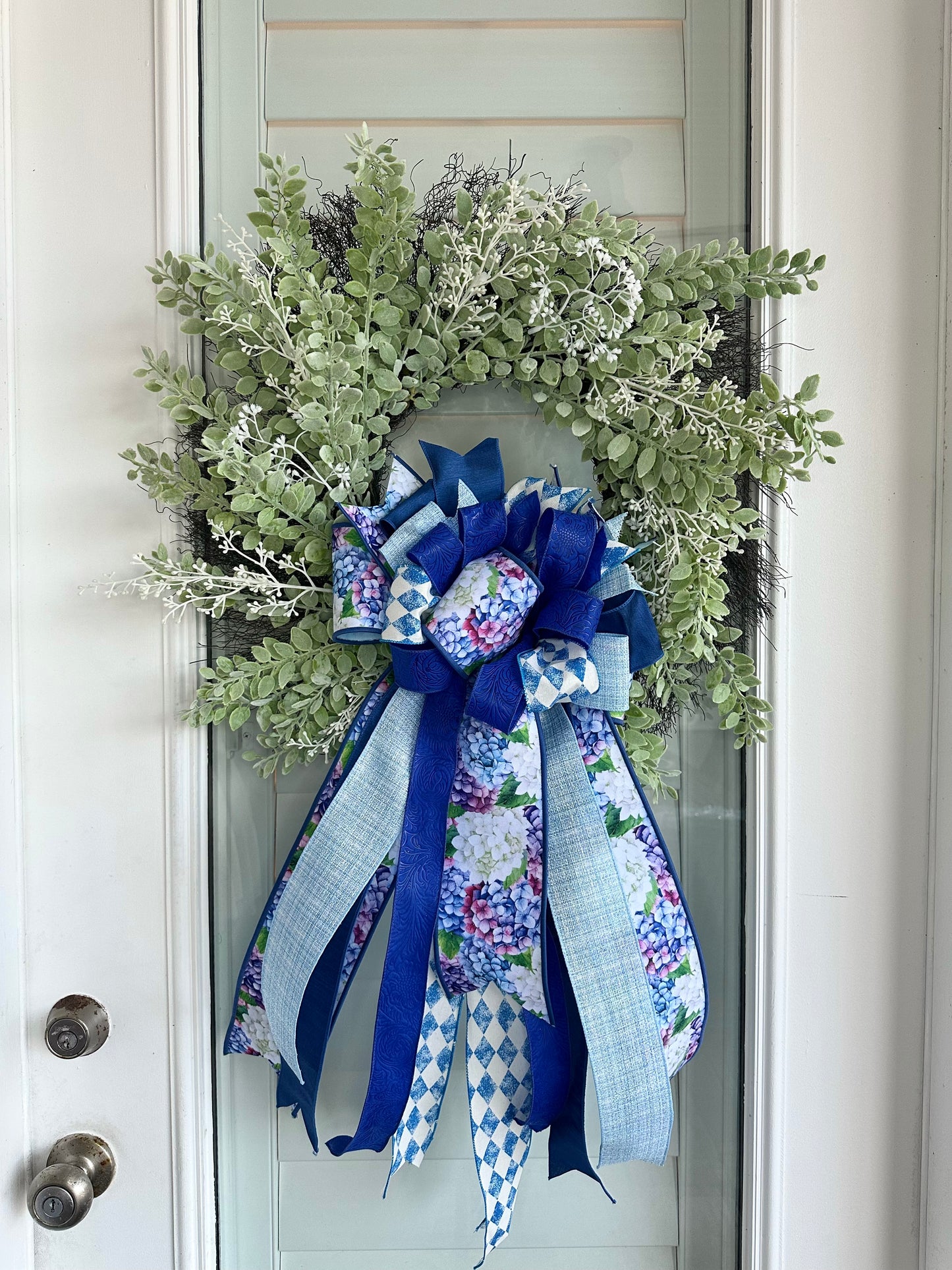 White eucalyptus, and berries with blue, light blue and floral ribbons