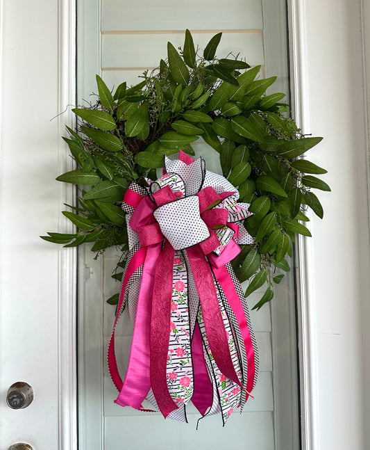 Eucalyptus and Berry Wreath with hot pink, black and white ribbons.